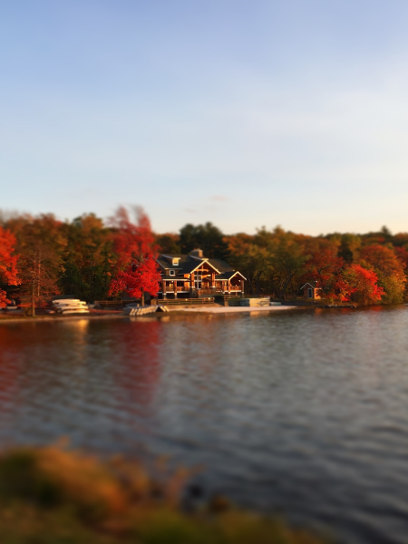 Minisink Lodge, surrounded by brightly colored fall trees, sits on the shore of fairview lake