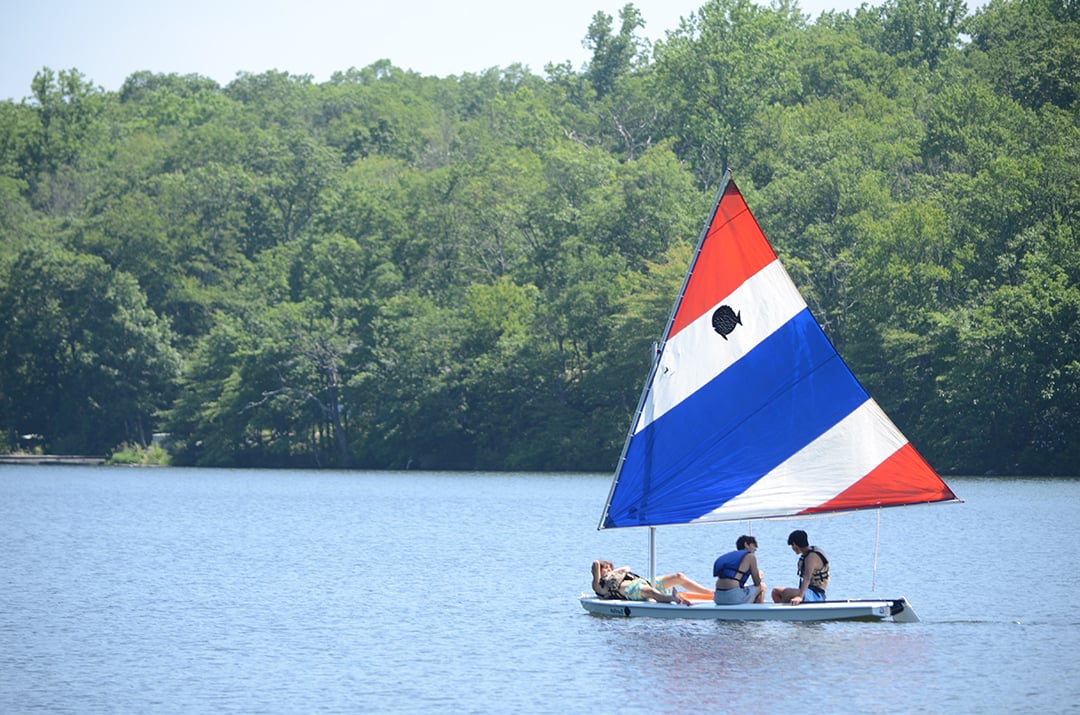 Sunfish sailboat gliding across the lake